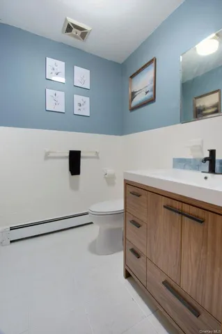 a bathroom with a sink a mirror and a toilet