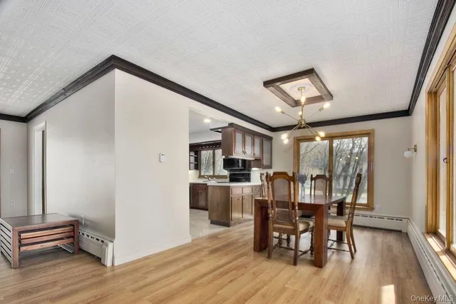 a view of a dining room with furniture window and wooden floor
