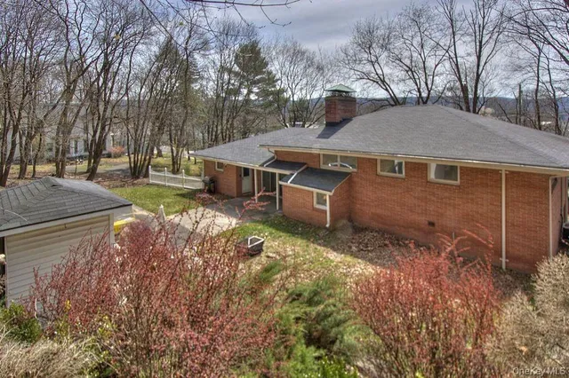 a view of a house with a yard and tree s