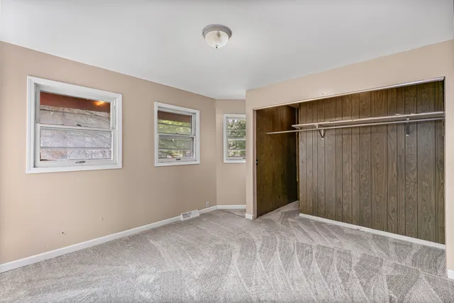 a view of an empty room with closet area