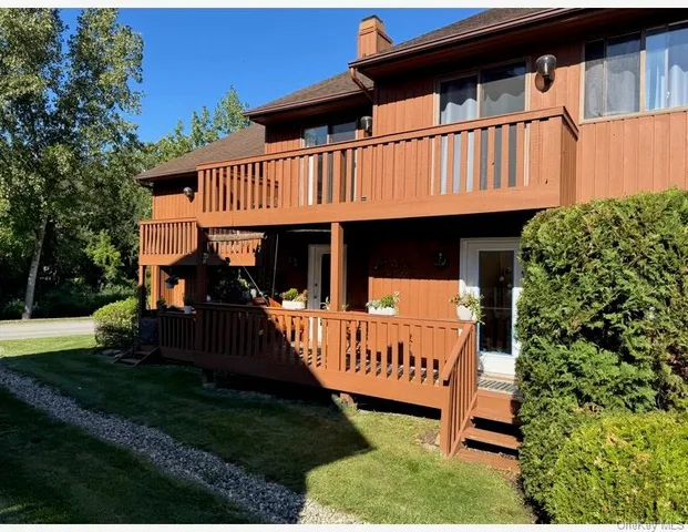 a view of a house with backyard and porch