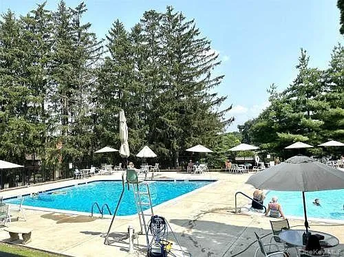 a swimming pool with an outdoor seating and yard