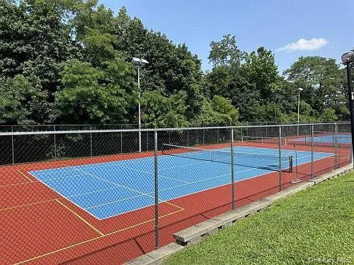a view of a tennis court with trees in the background