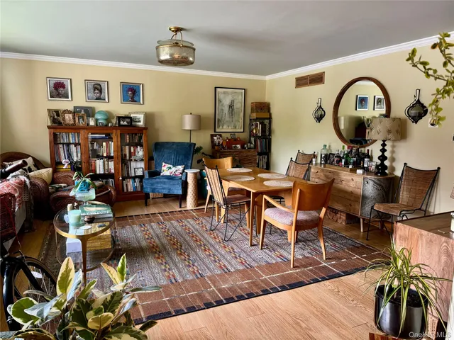 a living room filled with furniture a rug and a window