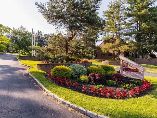 a view of a swimming pool with lawn chairs and a big yard