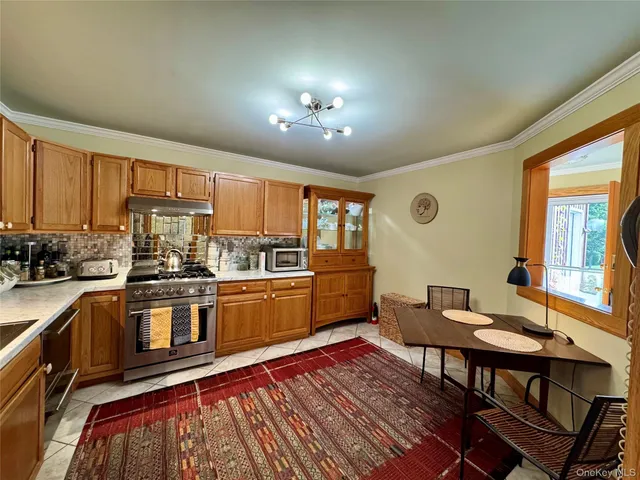 a kitchen with a table chairs stove and refrigerator