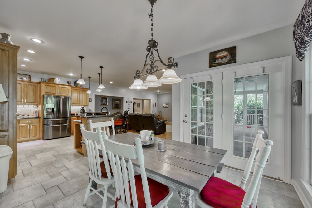 7880 Pinewood Road Fairview, TN 37062 - Photo 13 of 46 a view of a dining room and livingroom with furniture wooden floor a chandelier