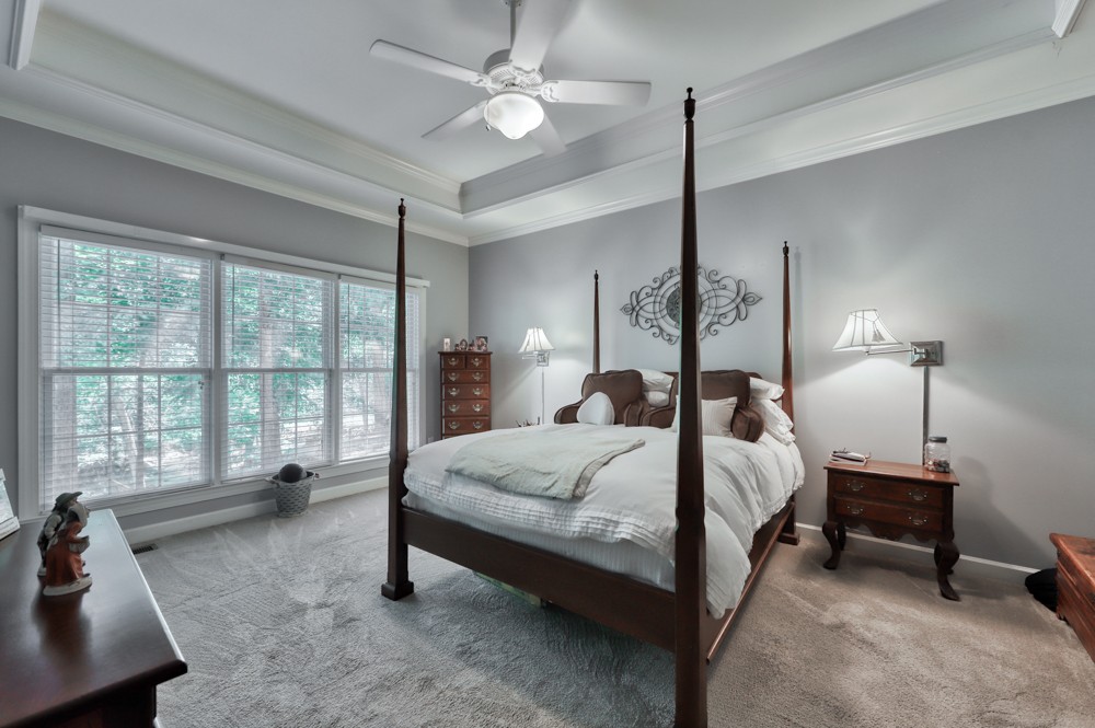 7880 Pinewood Road Fairview, TN 37062 - Photo 18 of 46 a bedroom with a bed a chandelier and a large window