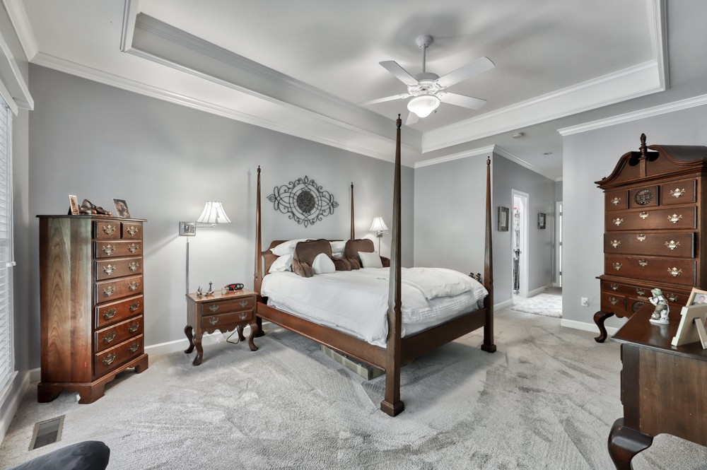 7880 Pinewood Road Fairview, TN 37062 - Photo 19 of 46 a bedroom with a bed and a chandelier