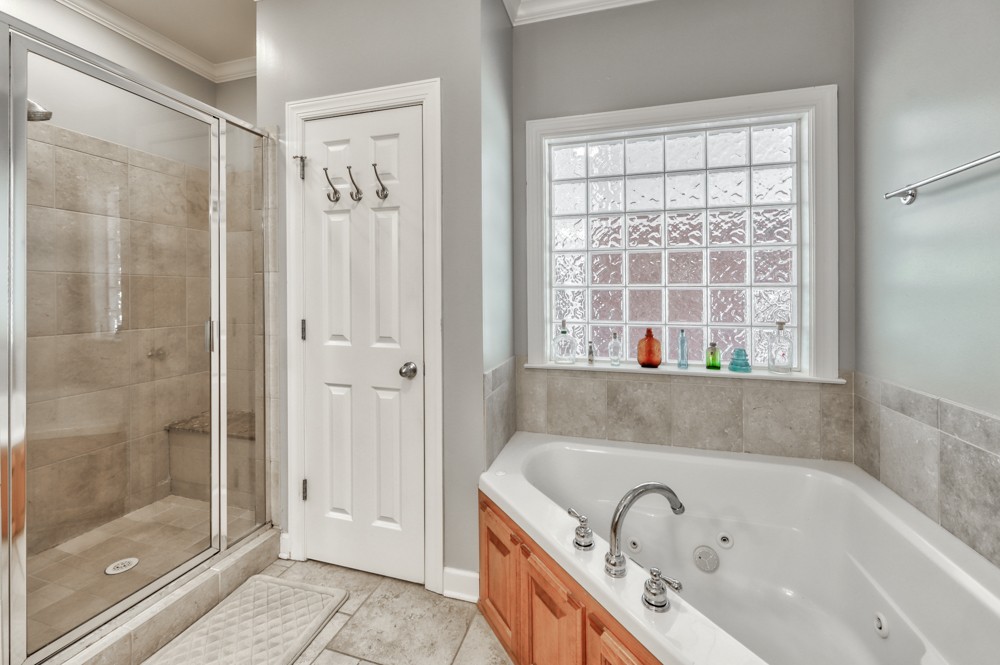7880 Pinewood Road Fairview, TN 37062 - Photo 20 of 46 a bathroom with a bathtub and a shower