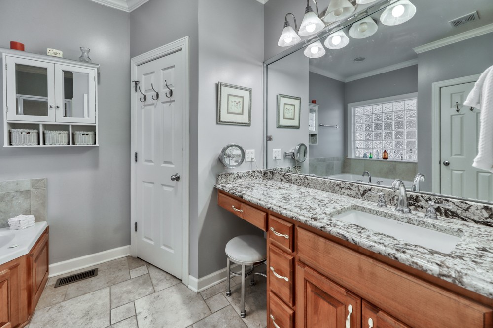 7880 Pinewood Road Fairview, TN 37062 - Photo 21 of 46 a bathroom with a granite countertop sink and a mirror