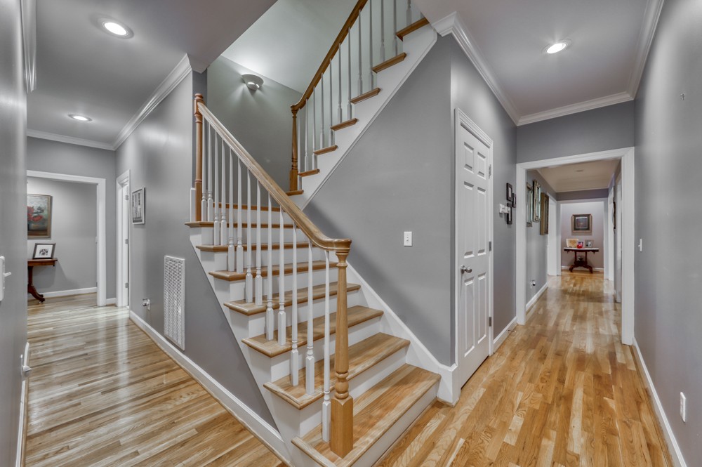 7880 Pinewood Road Fairview, TN 37062 - Photo 29 of 46 a view of a hallway with wooden floor and stairs