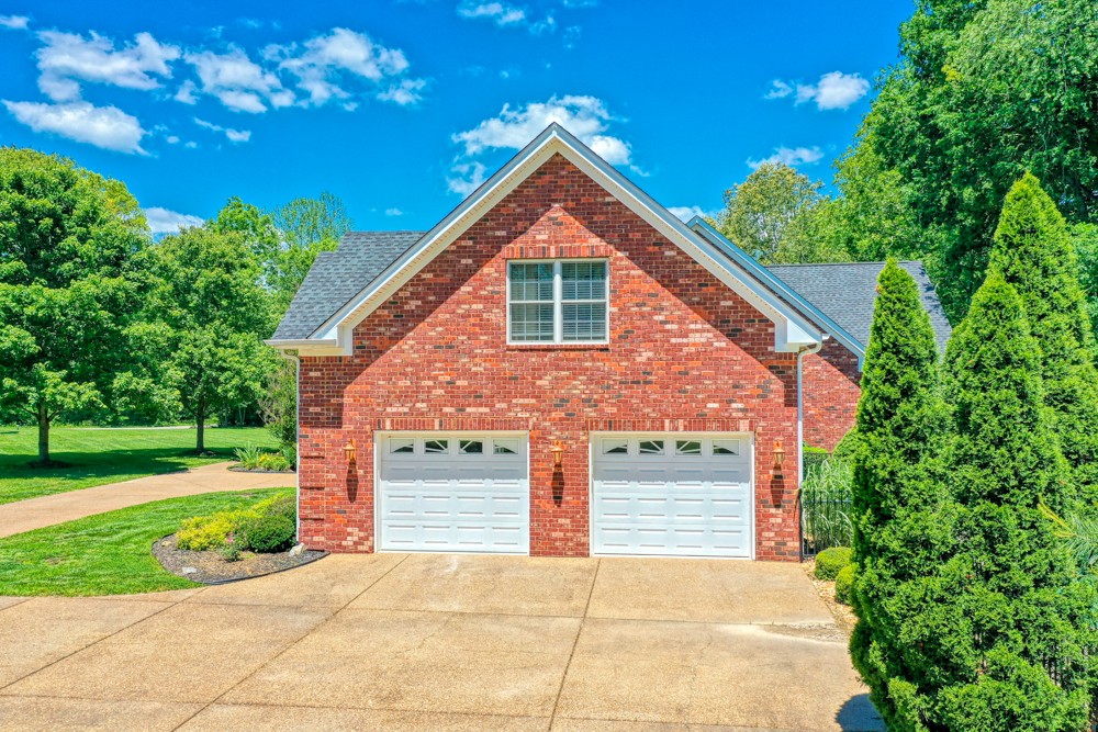 7880 Pinewood Road Fairview, TN 37062 - Photo 33 of 46 a front view of a house with a yard and garage