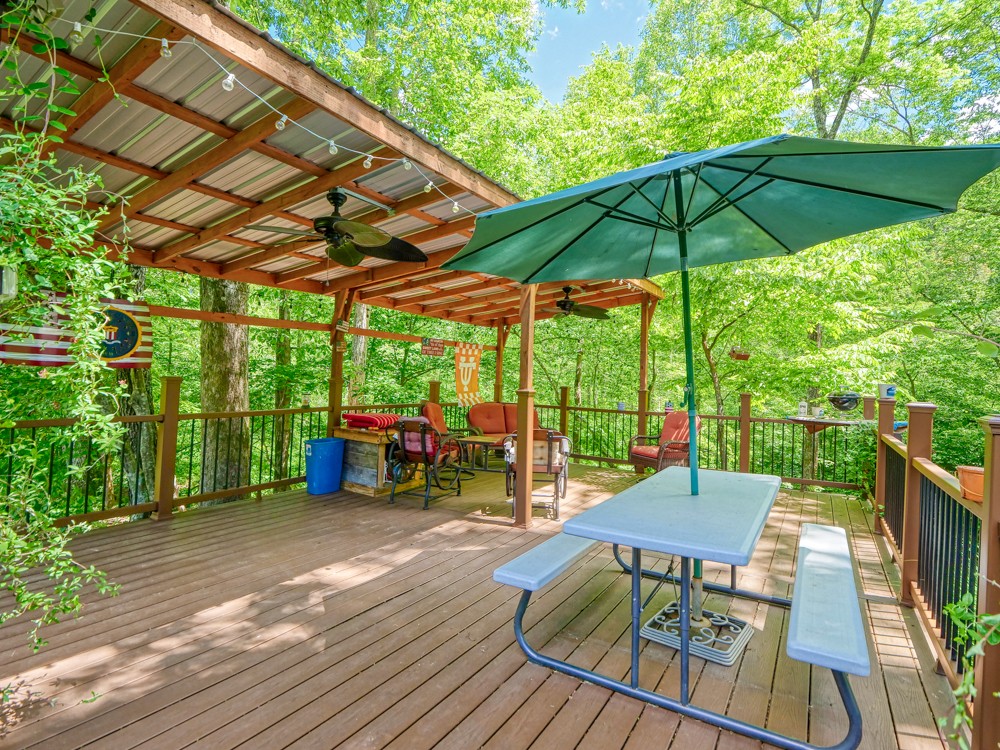 7880 Pinewood Road Fairview, TN 37062 - Photo 38 of 46 a view of deck with table and chairs under an umbrella