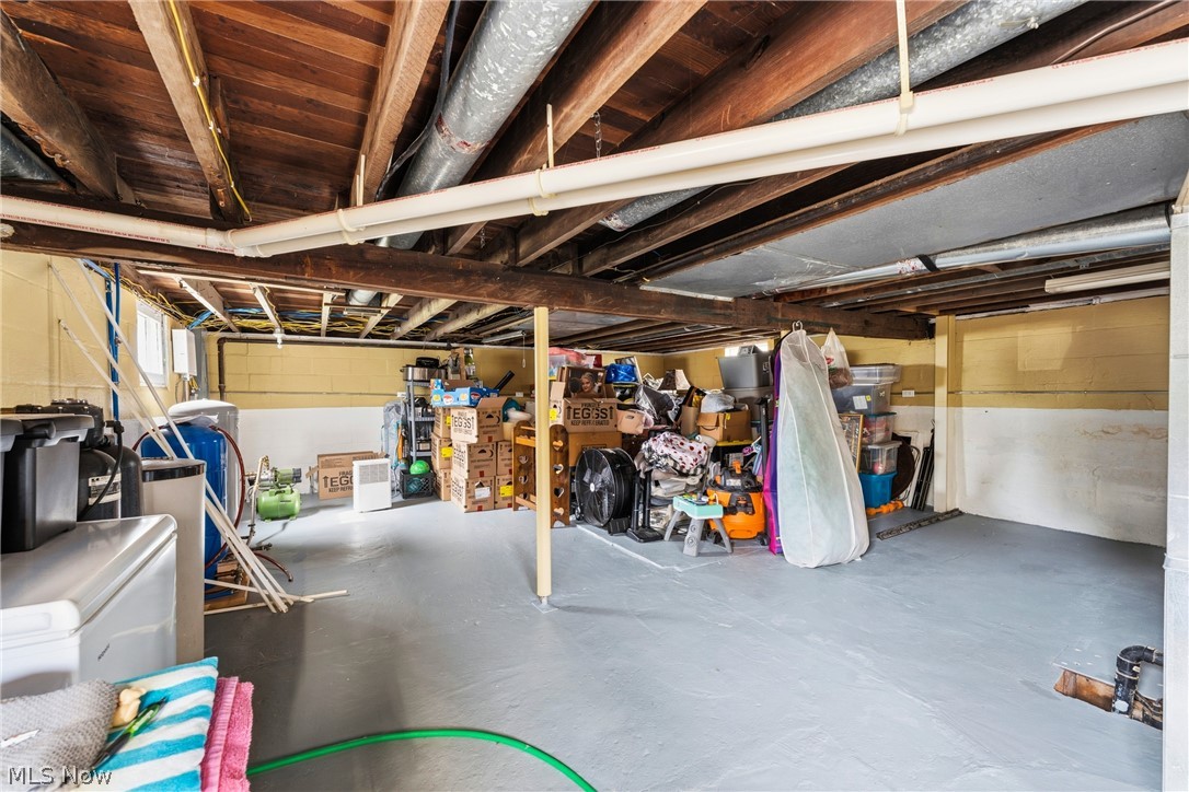 258 Randolph Road Mogadore, OH 44260 - Photo 26 of 49 Spacious utility basement with painted concrete flooring and exposed ceiling joists