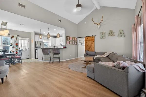 a living room with furniture and wooden floor