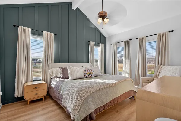 a bedroom with a bed window and walk in closet