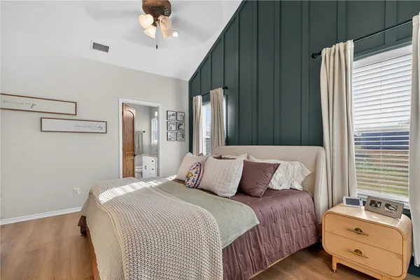 a bedroom with a bed dresser and a window