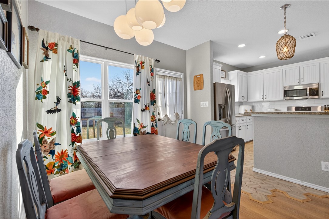 20401 County Road 1740 Mathis, TX 78368 - Photo 17 of 35 a view of kitchen with stainless steel appliances furniture refrigerator dining table and chairs