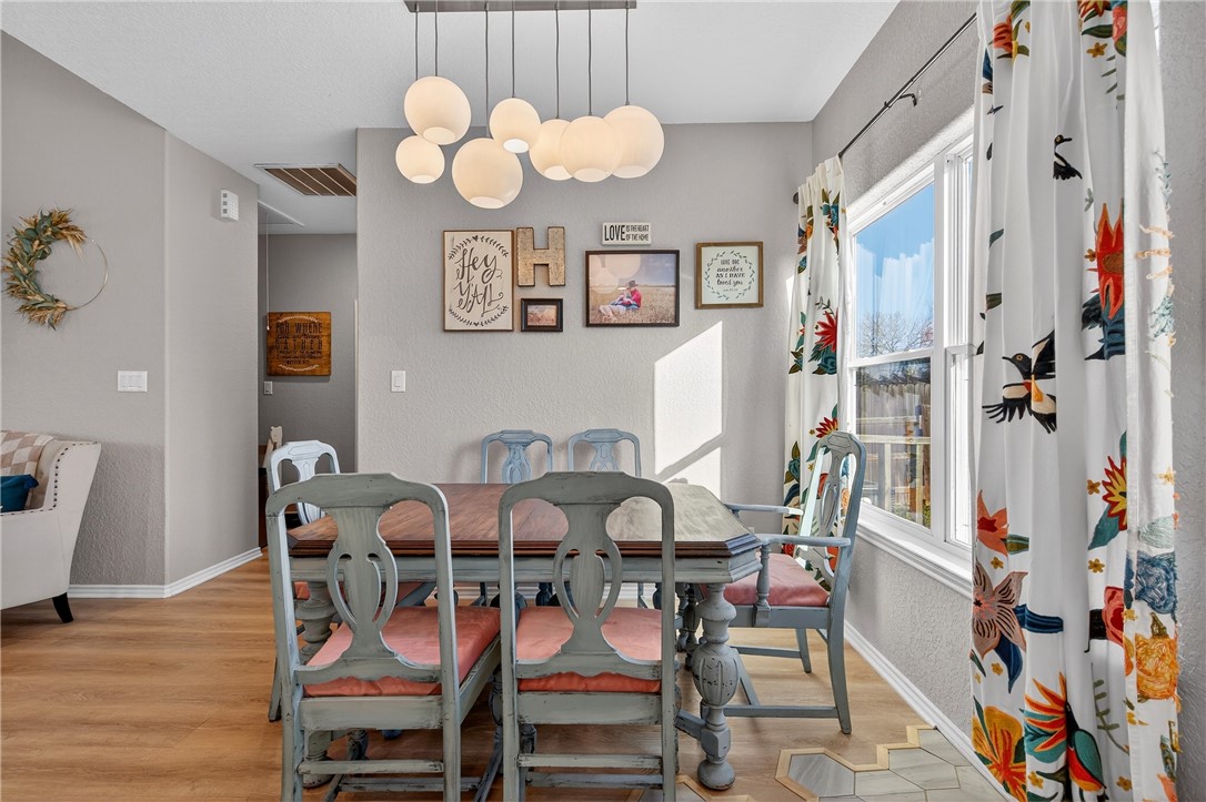 20401 County Road 1740 Mathis, TX 78368 - Photo 18 of 35 a view of a dining room with furniture and chandelier