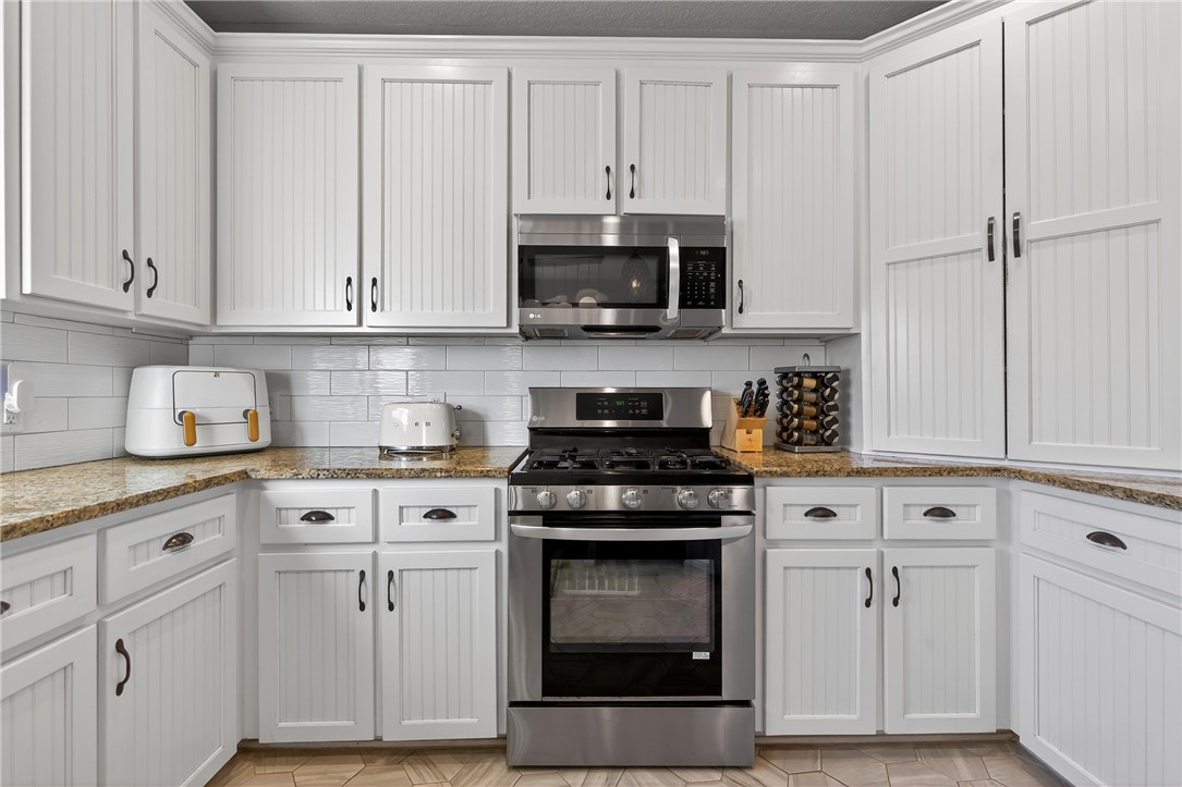 20401 County Road 1740 Mathis, TX 78368 - Photo 21 of 35 a kitchen with white cabinets and appliances