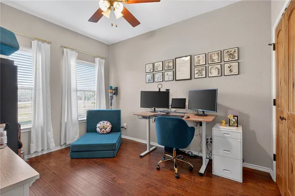 a workspace with wooden floor and a window