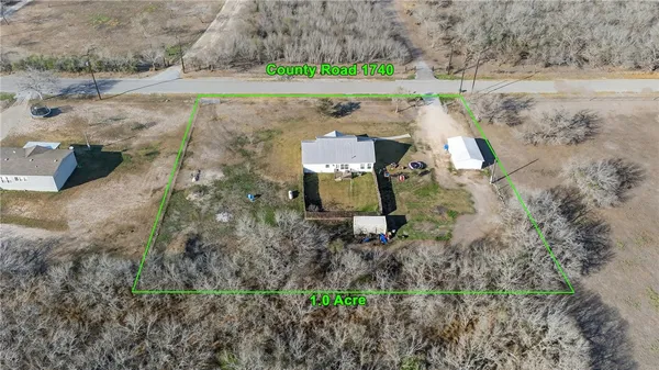 an aerial view of a house with a yard