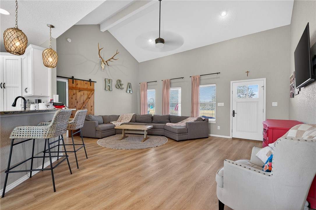 20401 County Road 1740 Mathis, TX 78368 - Photo 9 of 35 a living room with furniture kitchen view and a flat screen tv