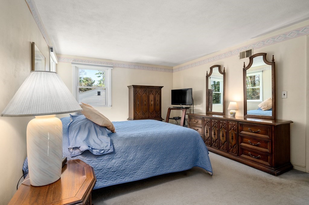 32 Eaton Road Framingham, MA 01701 - Photo 11 of 30 a bedroom with a bed and lamp with window