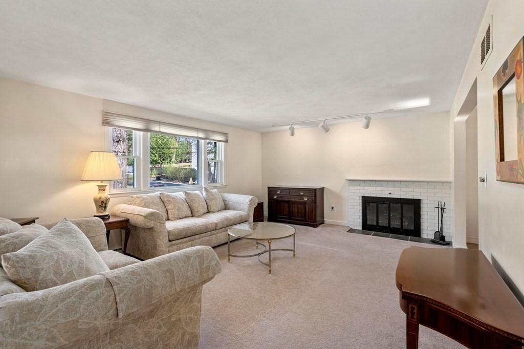32 Eaton Road Framingham, MA 01701 - Photo 3 of 30 a living room with furniture a fireplace and a large window