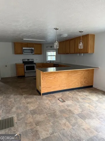 a kitchen with stainless steel appliances a stove and more cabinets