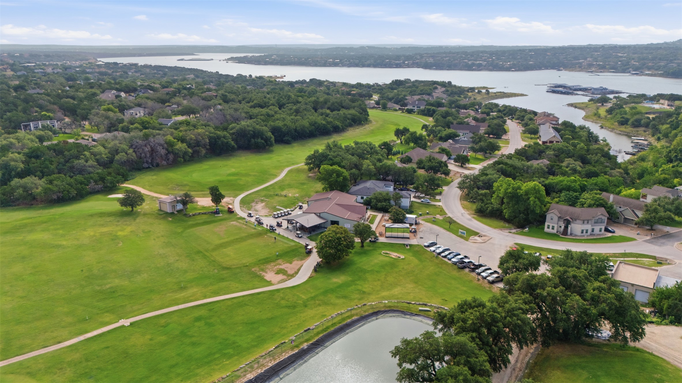 700 Augusta Circle Point Venture, TX 78645 - Photo 30 of 35 Overlooking a golf course and lake, this aerial view highlights community living with ample recreation.