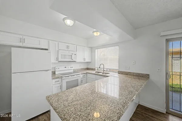 a kitchen with kitchen island a sink stove and refrigerator