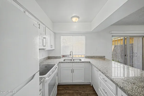 a kitchen with a sink stove and cabinets