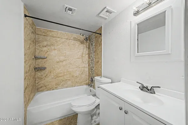 a bathroom with a sink mirror toilet and bathtub