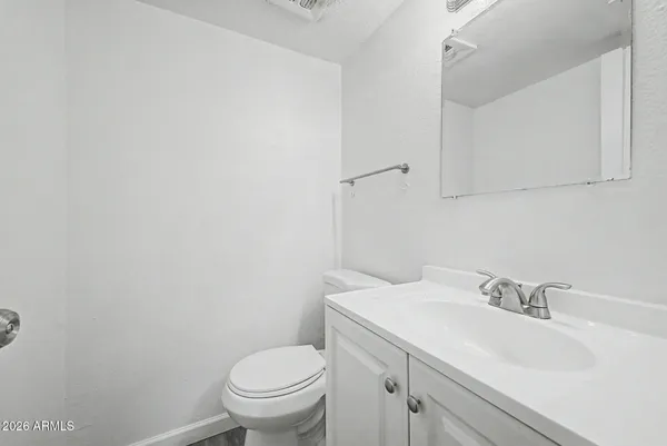 a bathroom with a sink toilet and a mirror