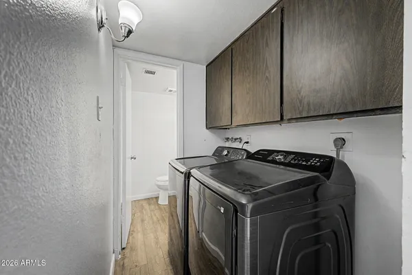 a utility room with sink dryer and washer