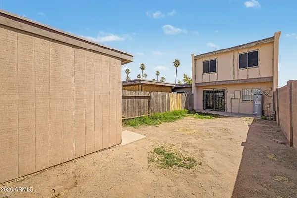 a view of a house with a backyard space