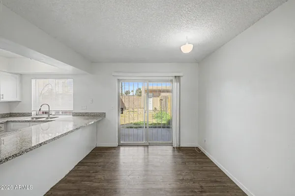 a view of a kitchen with a sink and wooden floor