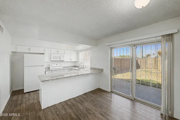 a kitchen with stainless steel appliances granite countertop a stove and a refrigerator