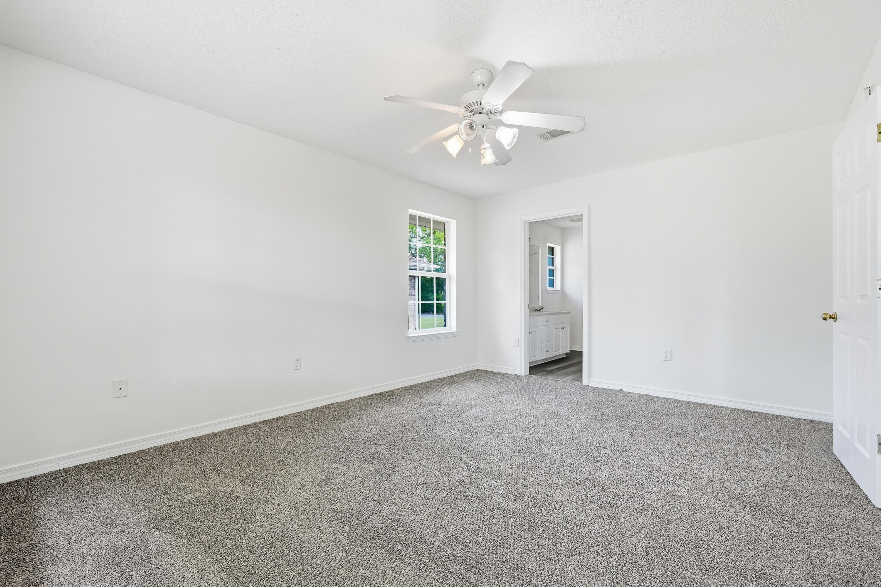 4087 Audiss Road Milton, FL 32583 - Photo 22 of 34 an empty room with windows and fan