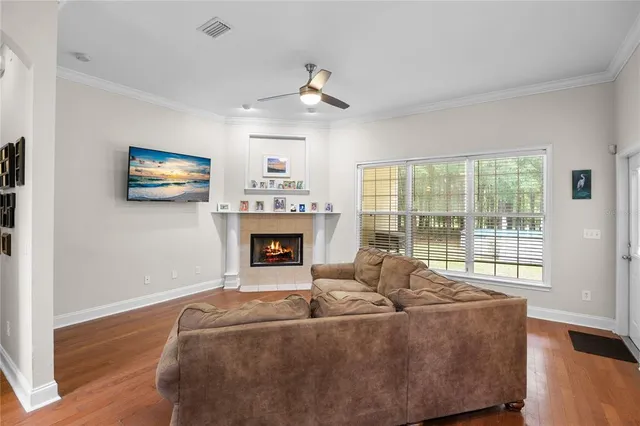 a living room with furniture large window and fireplace