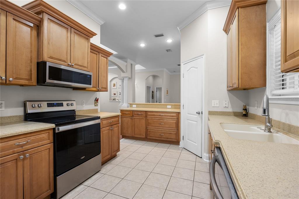 21737 Old Providence Road Alachua, FL 32615 - Photo 13 of 29 a kitchen with stainless steel appliances a stove sink microwave and cabinets