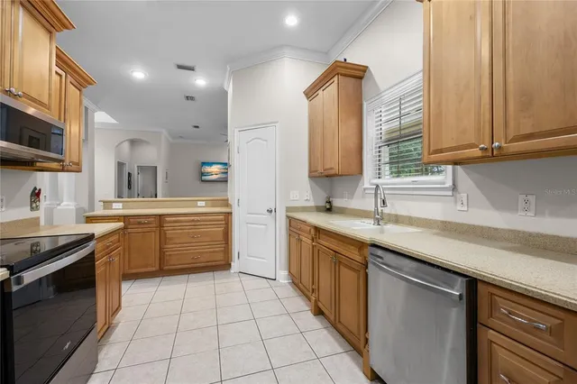 a kitchen with a sink stove and cabinets