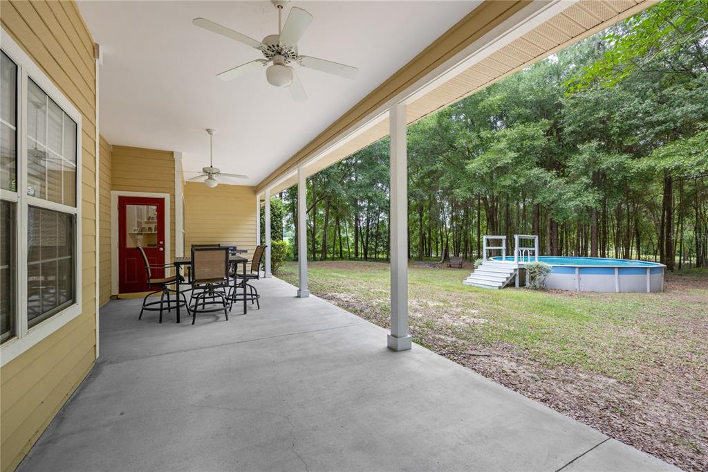 21737 Old Providence Road Alachua, FL 32615 - Photo 6 of 29 a view of a porch with chairs and backyard