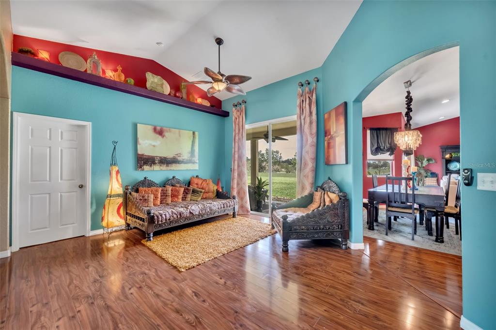 4946 Northeast 124th Road Oxford, FL 34484 - Photo 6 of 69 a living room with furniture a wooden floor and a large window