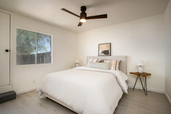 a bedroom with a bed and a painting on the wall