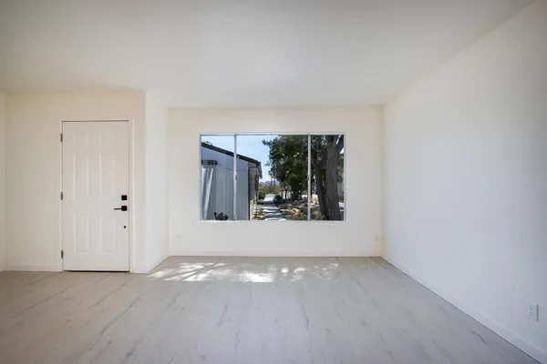 wooden floor in an empty room with a window