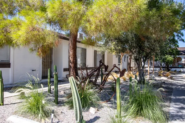 a backyard of a house with table and chairs