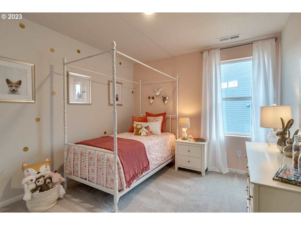 2267 30th Place Springfield, OR 97477 - Photo 8 of 13 a bedroom with a bed and a mirror
